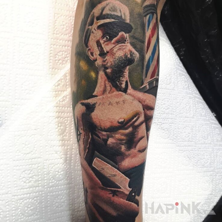 Tattoo Popeye in faces motif and realistic style on the forearm