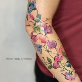 Tattoo Colorful flowers on the forearm motif: colorful style: Watercolor
