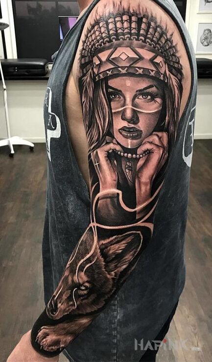 Tattoo Indianka z wilkiem in black and gray motif and realistic style on the forearm