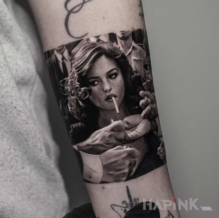 Tattoo Monicca Bellucci in faces motif and realistic style on the forearm