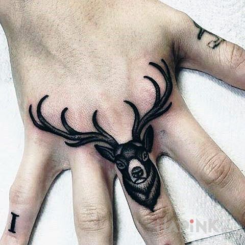 Tattoo Jelonek in black and gray motif and graphic / illustrative style on the hand