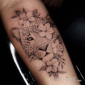 Tattoo Leopard in flowers on the forearm motif: animals style: graphic / illustrative