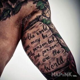 Tattoo The whole world on the upper arm motif: lettering style: calligraphy