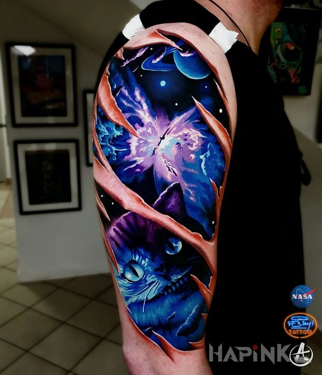 Tattoo Kosmos in cosmos motif and graphic / illustrative style on the upper arm