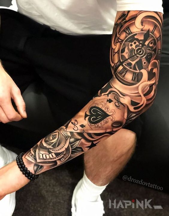Tattoo As pod zegarem in objects motif and realistic style on the forearm