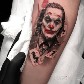 Tattoo Joker among the cards on the forearm motif: 3D style: realistic