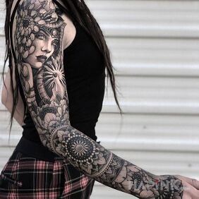Tattoo Portrait of a woman entwined with flowers on the upper arm motif: mandalas style: graphic / illustrative