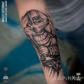 Tattoo Anubis on the forearm motif: characters style: graphic / illustrative