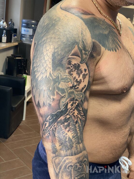 Tattoo Orzeł niedźwiedź wilk księżyc las in black and gray motif and realistic style on the upper arm