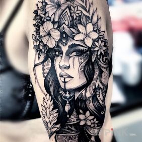 Tattoo Girl in a crown of flowers on the upper arm motif: flowers style: graphic / illustrative