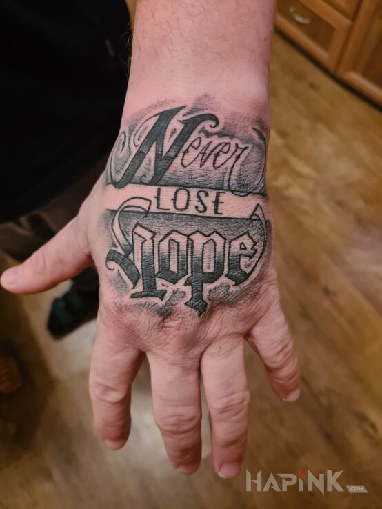Tattoo I wleciał kolejny ? in lettering motif and calligraphy style on the hand