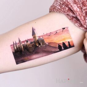 Tattoo Beautiful castle on the upper arm motif: fantasy style: realistic