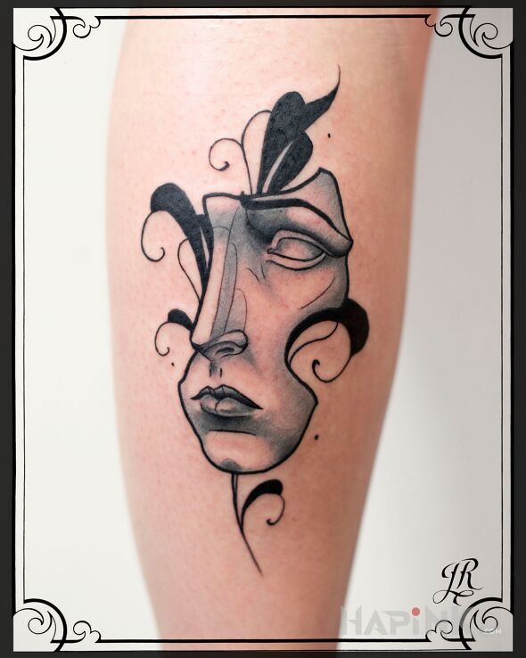 Tattoo Maska in faces motif and graphic / illustrative style on the calf