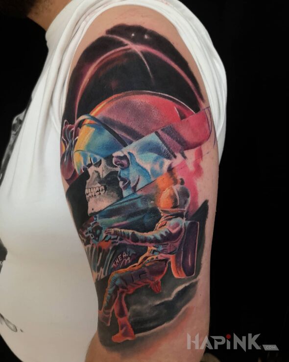 Tattoo Kosmos in skulls motif and surrealistic style on the upper arm
