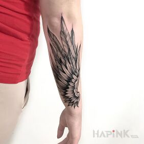 Tattoo Wing on the forearm motif: wings style: graphic / illustrative