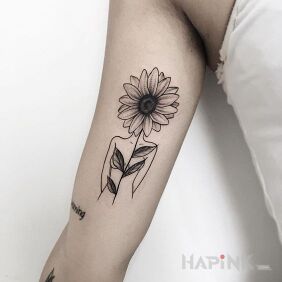 Tattoo Sunflower head on the upper arm motif: flowers style: graphic / illustrative
