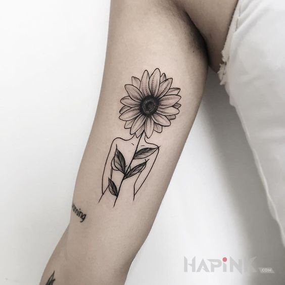 Tattoo Słonecznikowa główka in black and gray motif and graphic / illustrative style on the upper arm