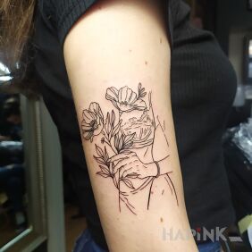 Tattoo Woman on the upper arm motif: flowers style: contour / linework