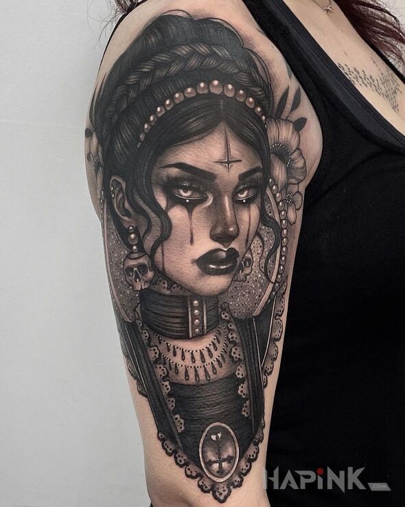 Tattoo Z oczu łezki in black and gray motif and realistic style on the upper arm