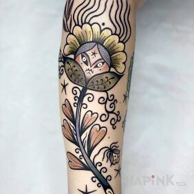 Tattoo Folkloristic flower on the forearm motif: colorful style: graphic / illustrative
