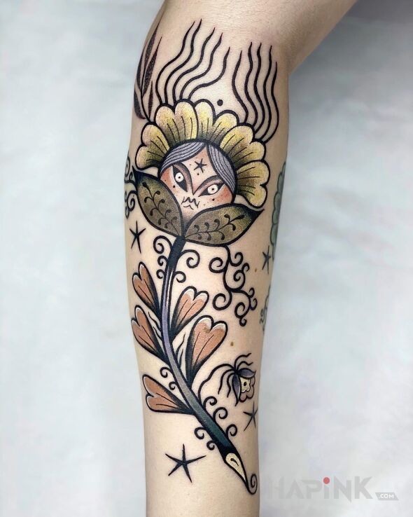 Tattoo Folklorystyczny kwiat in flowers motif and graphic / illustrative style on the forearm