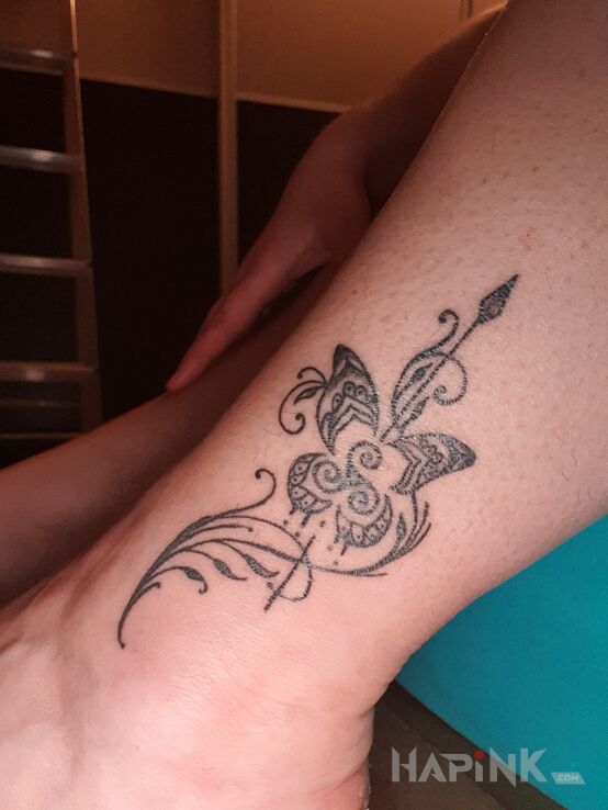 Tattoo Mandala in black and gray motif and graphic / illustrative style near the ankle