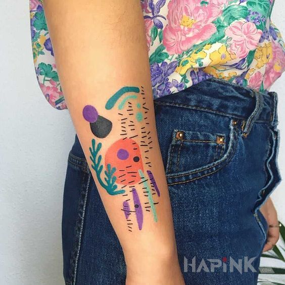 Tattoo Abstrra in colorful motif and abstract style on the forearm