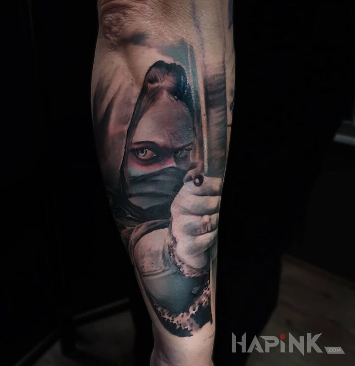 Tattoo Łuczniczka in black and gray motif and realistic style on the forearm