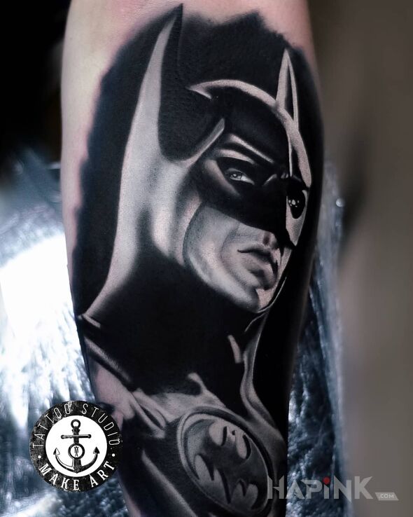 Tattoo Batman in faces motif and realistic style on the calf