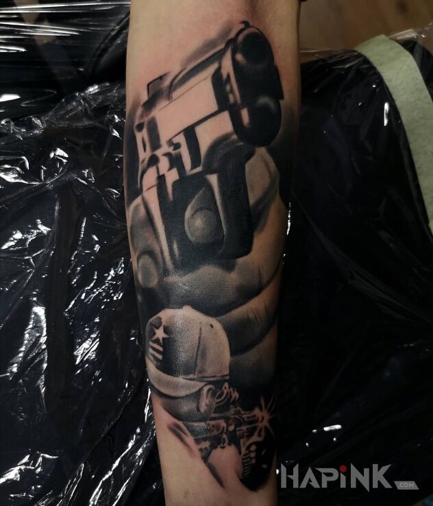 Tattoo Gun in characters motif and realistic style on the forearm