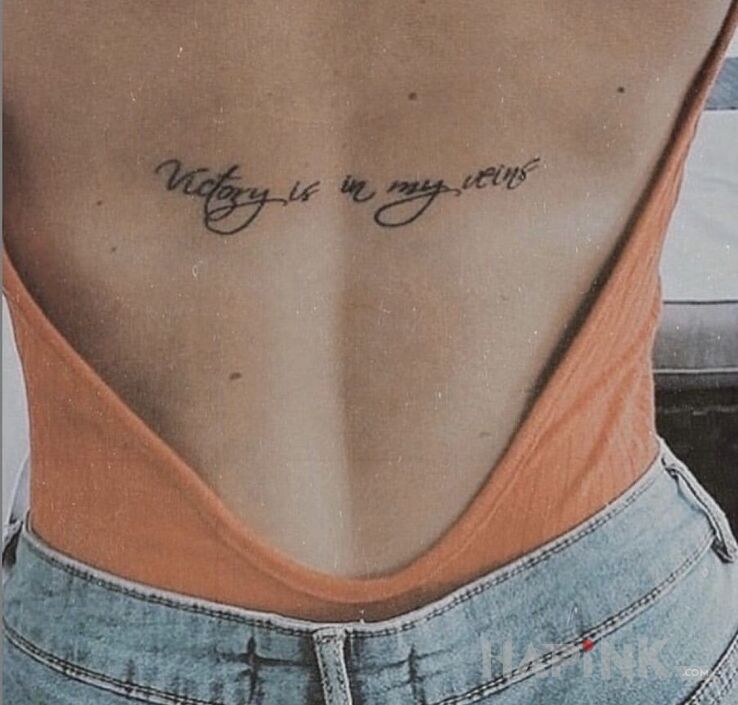 Tattoo Zwycięstwo w żyłach in lettering motif and calligraphy style on the back