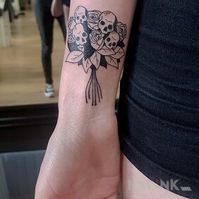 Tattoo Bouquet of skulls on the forearm motif: black and gray style: graphic / illustrative