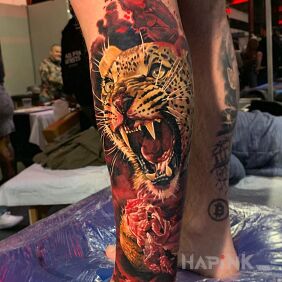 Tattoo Leopard in blood on the calf motif: animals style: realistic