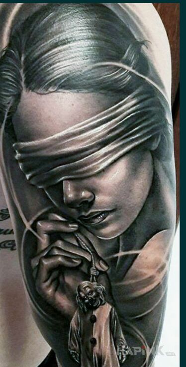 Tattoo Cudo nie tatuaz in faces motif and realistic style on the upper arm