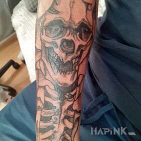 Tattoo Skull on the forearm motif: black and gray style: graphic / illustrative
