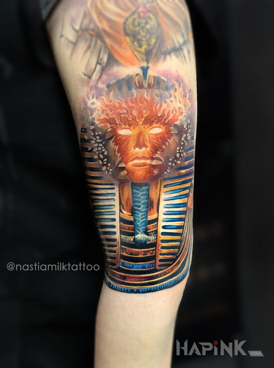 Tattoo Faraon in faces motif and surrealistic style on the upper arm