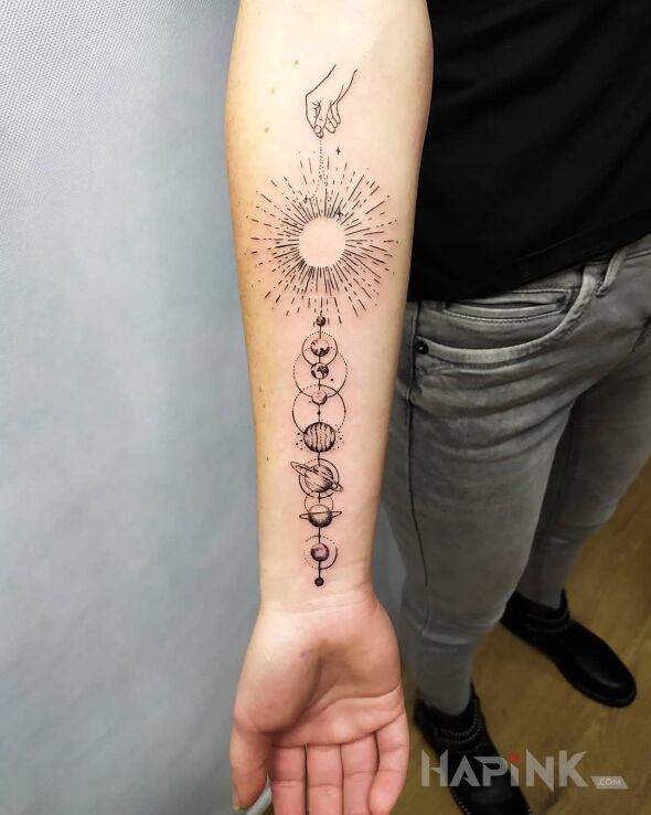 Tattoo Kosmos, planety in cosmos motif and graphic / illustrative style on the forearm