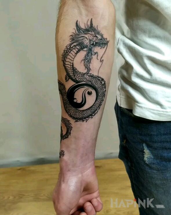 Tattoo Smok in fantasy motif and graphic / illustrative style on the forearm