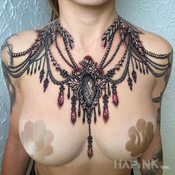 Tattoo Kosztowności in ornaments motif and realistic style on the chest