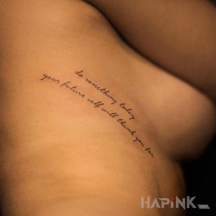 Tattoo Zrób coś dzisiaj! in lettering motif and calligraphy style on the ribs