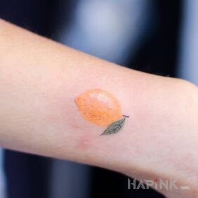 Tattoo Lemon on the forearm motif: colorful style: handpoke