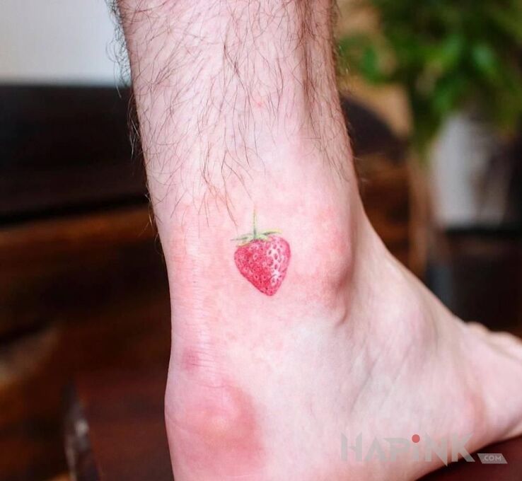 Tattoo Truskaweczka in colorful motif and minimalistic style near the ankle
