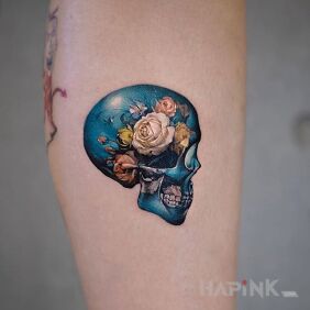 Tattoo Skull in flowers on the forearm motif: colorful style: realistic