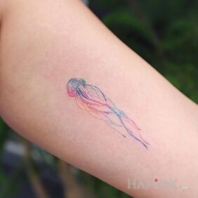 Tattoo Jellyfish on the upper arm motif: colorful style: handpoke