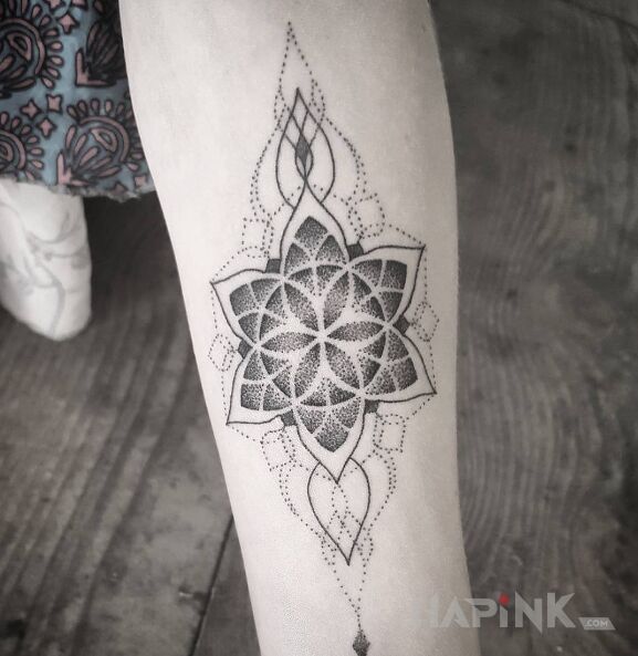 Tattoo Wykropkowana mandala in ornaments motif and graphic / illustrative style on the forearm
