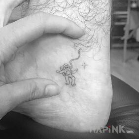 Tattoo Little one in space on the upper arm motif: black and gray style: minimalistic