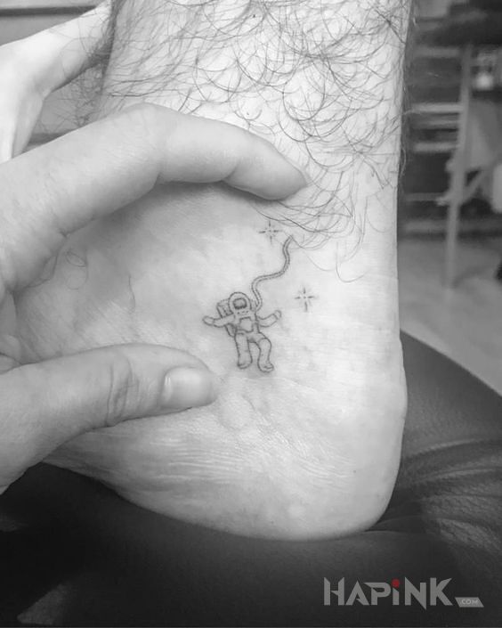 Tattoo Malec w kosmosie in black and gray motif and handpoke style on the upper arm