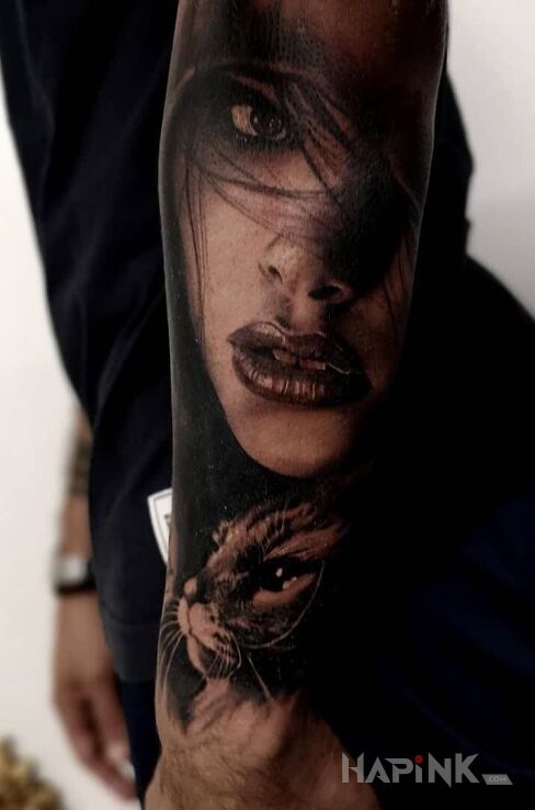Tattoo Kociara in colorful motif and realistic style on the forearm