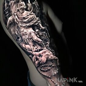 Tattoo Evil trampled by good on the upper arm motif: angels style: realistic