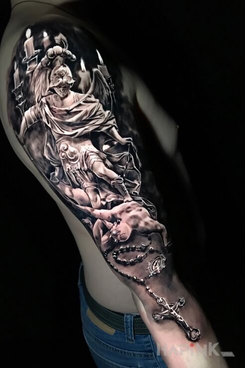 Tattoo Zło zdeptane przez dobro in angels motif and realistic style on the upper arm